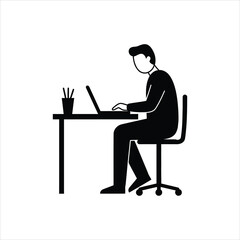 Fototapeta premium A silhouette of a person sitting at a desk and working on a laptop computer