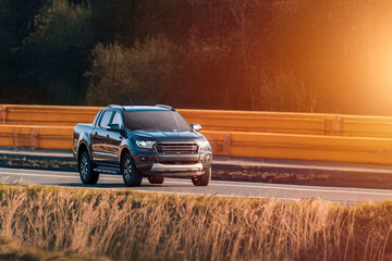 pickup truck driving on country road © AlexGo