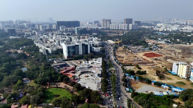Aerial footage of a developed city in India Hyderabad as the City of Destiny for IT and Pharmaceutical companies, modern office hubs, residential towers, and active construction corridors highlights
