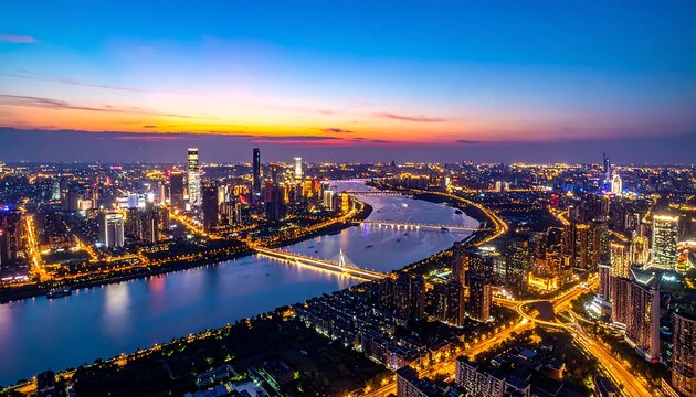 Illuminated city skyline at night with river curves and bridges