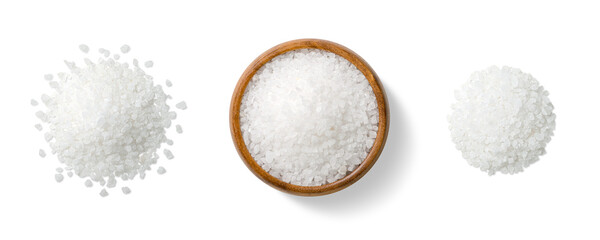 Top view of three piles of coarse sea salt crystals, scattered and arranged in a wooden bowl,...