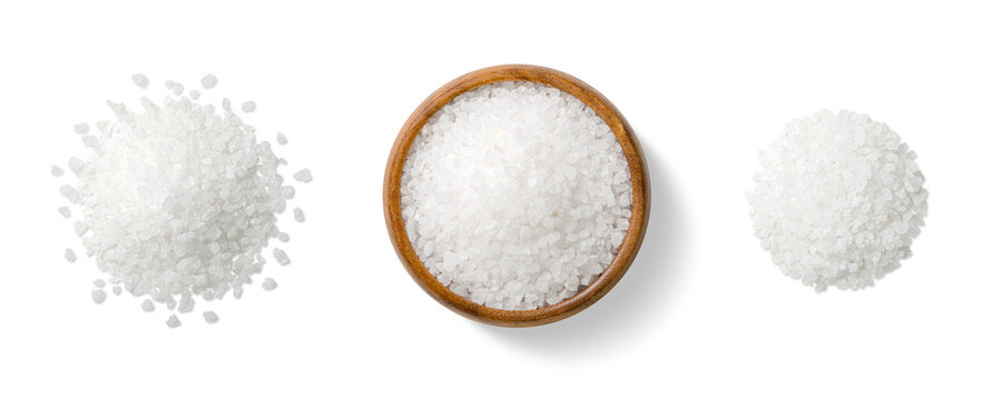 Top view of three piles of coarse sea salt crystals, scattered and arranged in a wooden bowl, isolated on a transparent background. Ideal for food design, packaging and culinary use.
