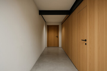 Fototapeta premium Long hallway with wooden furniture and a door at the end in a simple indoor space during daytime