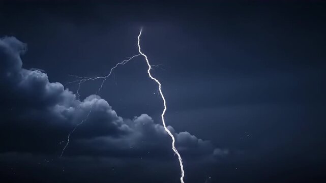 A spectacular bolt of lightning illuminates a stormy, dark sky, highlighting the raw power and beauty of nature's atmospheric phenomena during a powerful thunderstorm event