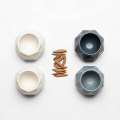 Minimalist flat lay of aromatic Oud wood chips and four geometric ceramic pots