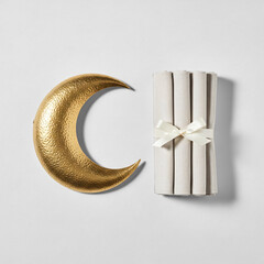 Golden Crescent Moon and Rolled Napkins for Ramadan or Eid Celebration
