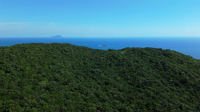 Aerial fly Blue Ocean Green Hill at East Santa Catarina Coast, Ilha Mata-fome Brazil