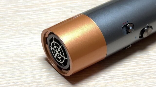 The internal motor of the high-tech hair styler rotates at high speed. This action forces air through the drying attachment, creating a powerful, high-pitched hum