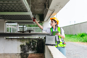 Female Field Analyst Collecting Data at Pumping Station