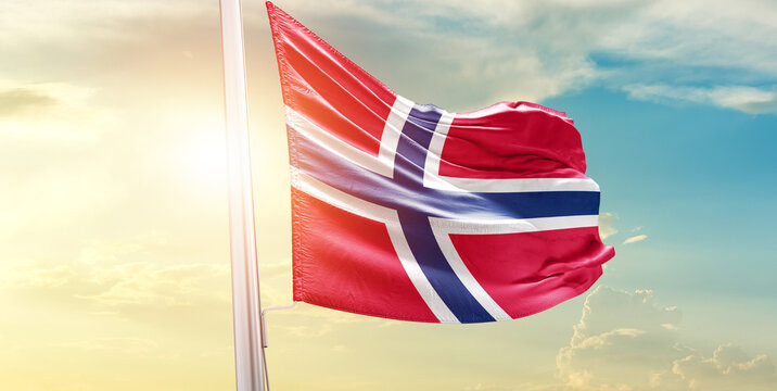 Norway national flag waves on soft sky.