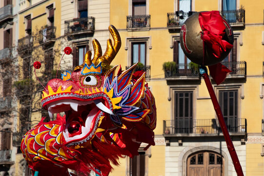 Red Dragon Head. Vibrant celebration of Chinese New Year on city streets with traditional dragons and dancers.  