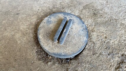 Dusty plastic drain covers on rough concrete floors, showcasing the concept of drainage and infrastructure maintenance.