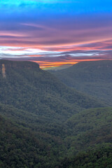 Fototapeta premium Beautiful flowing River in Fitzroy water Falls in Bowral NSW Australia beautiful colourful cloudy skies lovely waterfalls