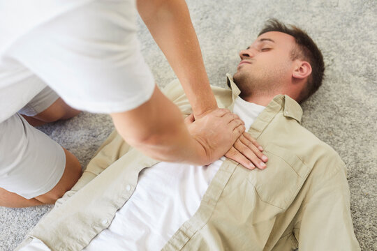 CPR chest compressions assist patient in emergency resuscitation. Hands press the chest of an unresponsive unconscious man. A rescuer gives first aid to patient. Lifesaving skills concept. 