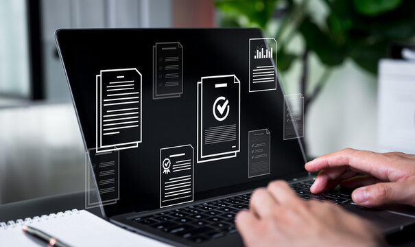 Businessman checking digital documents on laptop for online document management, validation process, file processing, and organization of electronic document files.