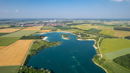 Aerial View of Hollenersee Lake in Munich, Germany on a Sunny Summer Day with Recreational Activities © Alfredo