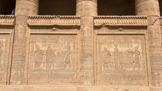 Ancient Mammisi chapel at Dendera, Egypt, a small ceremonial birth house attached to the larger Temple complex, built in stone and captured from an exterior ground level perspective.