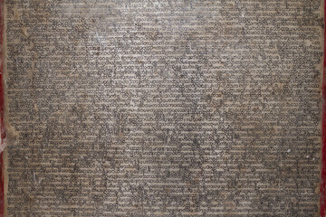 Close up of ancient pali scripture carved onto a marble slab. © Migara