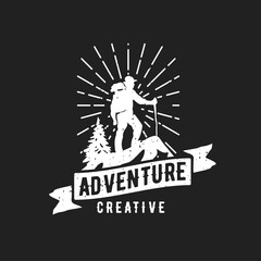 Naklejka premium Retro Outdoor Adventure Emblem with Hiker, Mountain Peak, Pine Tree, Sunburst, and 'Adventure Creative' Typography