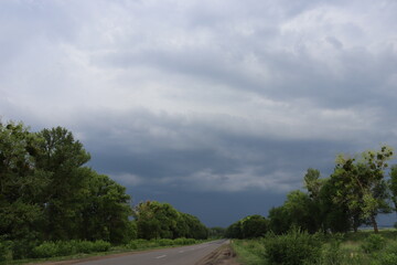 Fototapeta premium Empty road under dramatic storm clouds