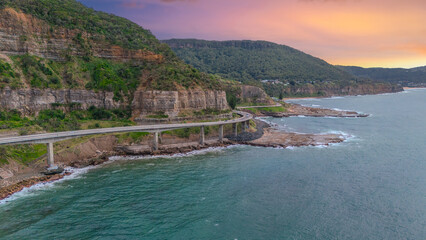 Obraz premium Sea Cliff Bridge on the southern coast of Sydney with sweeping Ocean Views and Mountain terrain. a major Bridge Road on the beautiful Australian coastline Australia