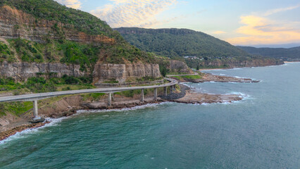 Fototapeta premium Sea Cliff Bridge on the southern coast of Sydney with sweeping Ocean Views and Mountain terrain. a major Bridge Road on the beautiful Australian coastline Australia