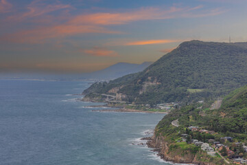 Fototapeta premium Sea Cliff Bridge on the southern coast of Sydney with sweeping Ocean Views and Mountain terrain. a major Bridge Road on the beautiful Australian coastline 
