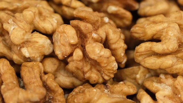 Macro raw walnuts without shell close up, rotation. Healthy vegan snack 