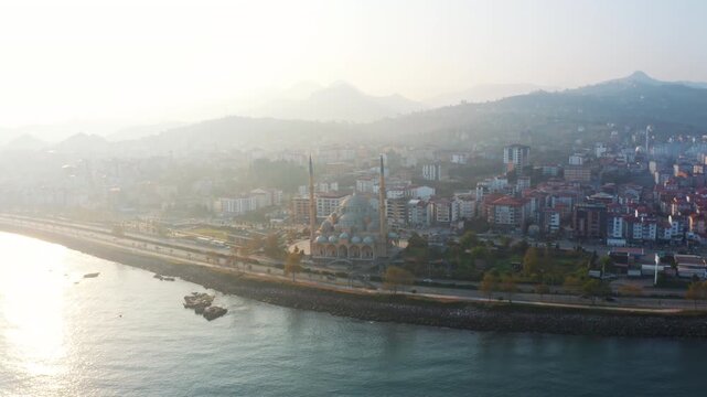 Panoramic View of Sarayburnu Mosque in Giresun, Turkey; Misty Morning by the Black Sea Coast with Cityscape and Ottoman Architecture, Drone Footage.