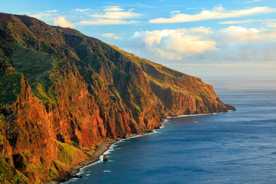 Madeira, Portugal - December 4, 2025: Golden sunset over the high cliffs and lighthouse of Ponta do Pargo on the western coast of the island.
