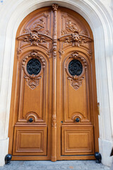 Old ornate door in Paris, France - typical old apartment building.