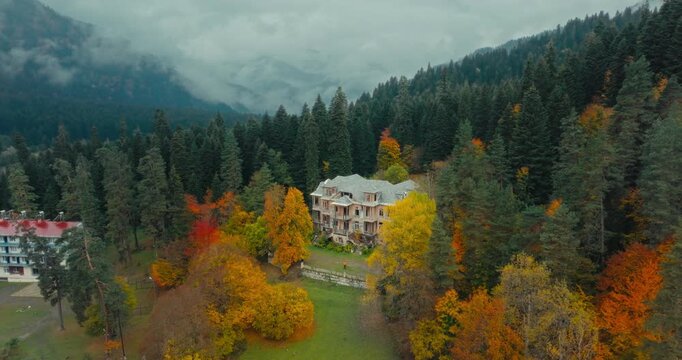 Stalin's historic summer house in Racha, Georgia, surrounded by autumn colors; drone footage with a forward dolly-in motion.
