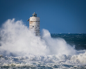Dramatic ocean storm and resilient coastal beacon, Mangiabarche of Calasetta