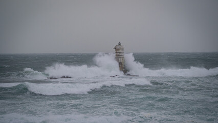 Powerful sea spray engulfing lighthouse tower, Mangiabarche Lighthouse