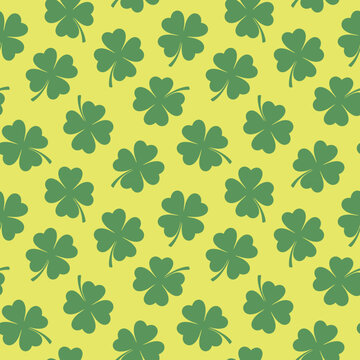 Seamless lucky clover pattern in green, white, yellow, and dark emerald hues