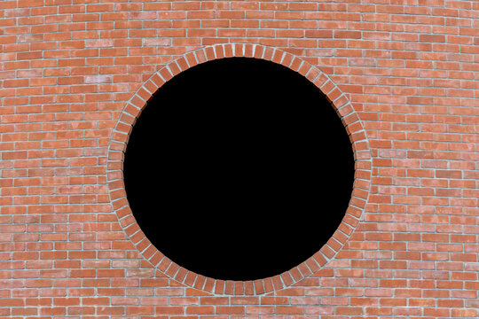 Dettaglio di un muro di mattoni con al centro un buco nero