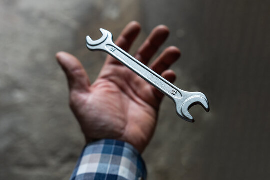 The mechanic throws the wrench out of his hand and it goes into free fall.