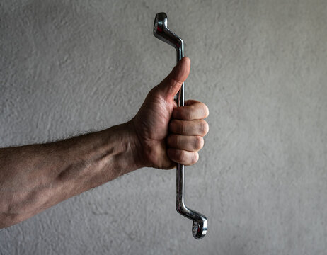 The mechanic throws the wrench out of his hand and it goes into free fall.