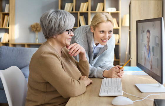 Senior daughter doctor telemedicine video consultation online. At home they use a computer for remote care, discussing concerns with a friendly physician. Clear concept of telehealth home care.
