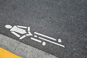 White cyclist symbol painted on an asphalt bike lane.