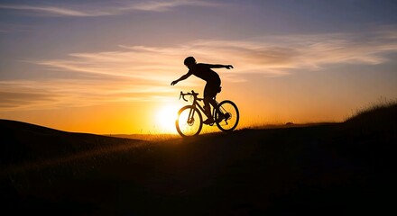 Obraz premium Silhouette of cyclist riding bicycle on hill against bright sunset sky during golden hour. Sport lifestyle concept