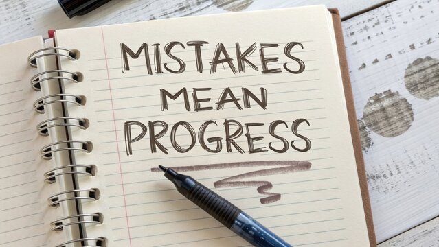 A notebook page with handwritten text about progress and mistakes