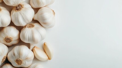 A collection of fresh garlic bulbs artfully arranged on a stark white surface, highlighting their textured skins and suggesting culinary, health, and natural qualities.