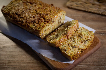 Freshly baked bread slices on a wooden cutting board with a soft background