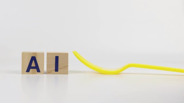 A cube-shaped AI sign with a man's hand holding colorful plastic blocks. Concept for a restaurant or kitchen setting.