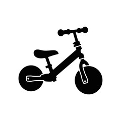 Silhouette of a childs balance bike.