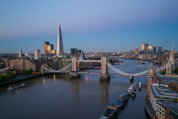 Obraz premium London skyline at dusk with Tower Bridge and The Shard illuminated over River Thames cityscape panorama