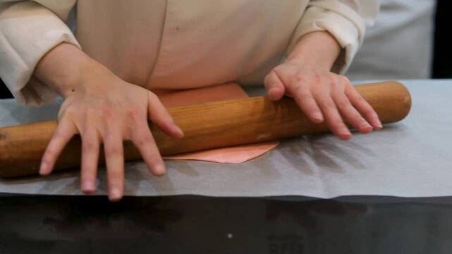 roll out pink mastic an unrecognizable woman with a rocking chair and hands
