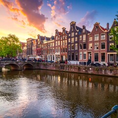 Naklejka premium A picturesque canal scene in a European city at sunset with colorful architecture lining the waterway and a dramatic sky