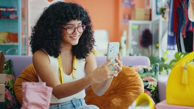 Beautiful young hispanic woman managing her home clothing e-commerce business from home - Female designer owns online shopping store, concepts of home business and reselling second hand accessories